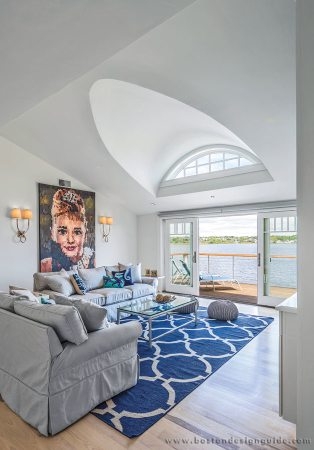 This is an example of a large coastal mezzanine living room in Burlington with white walls and light hardwood flooring.