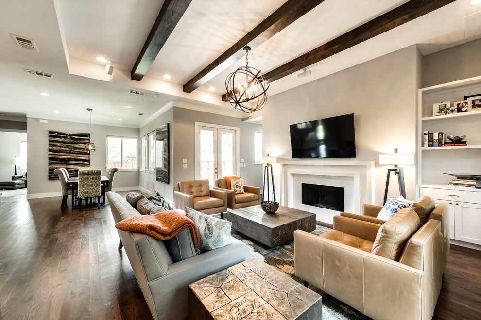 Living room - farmhouse open concept medium tone wood floor and brown floor living room idea in Dallas with gray walls, a standard fireplace, a tile fireplace and a wall-mounted tv