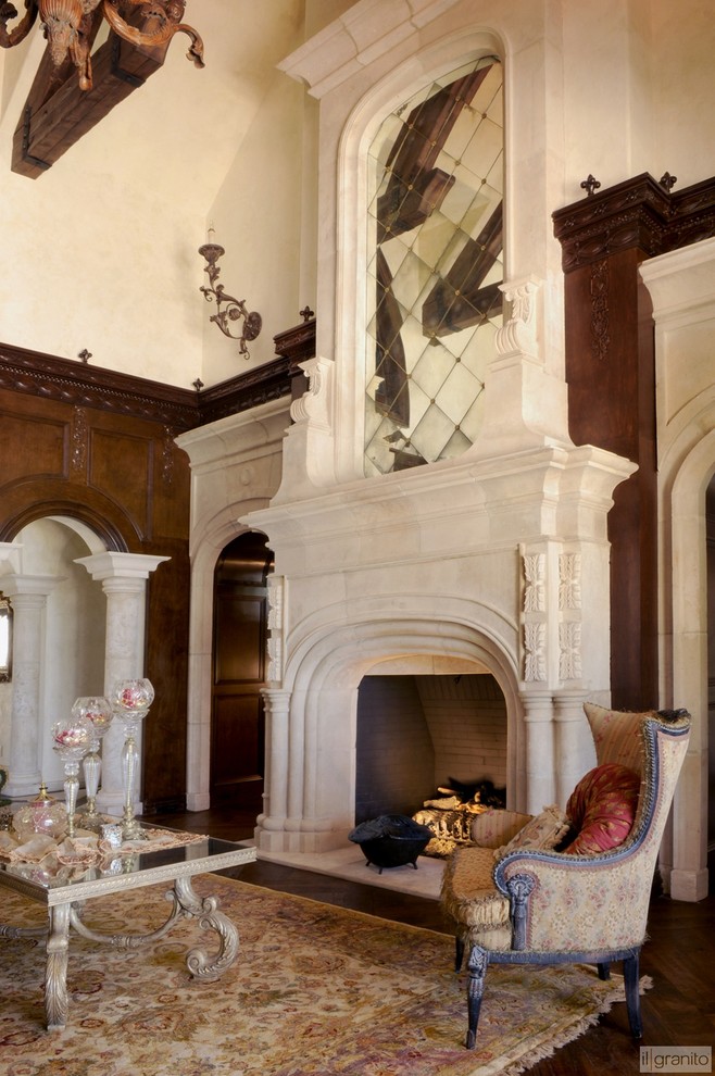 Photo of a mediterranean living room in Dallas with a standard fireplace and a stone fireplace surround.