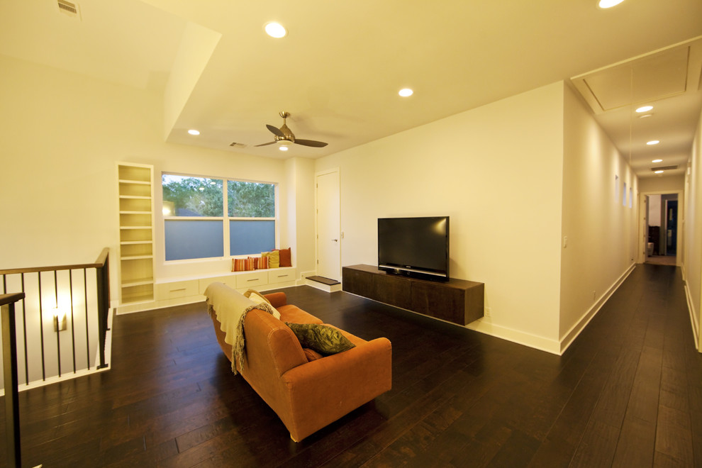 Photo of a contemporary living room in Houston with white walls, dark hardwood flooring, no fireplace and a freestanding tv.