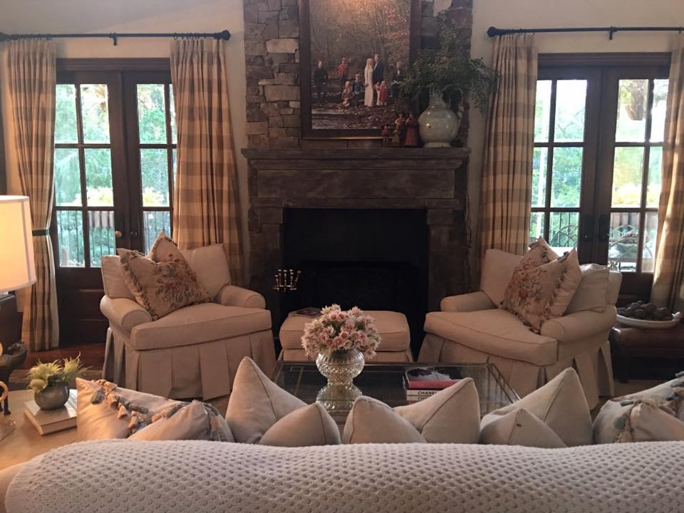 This is an example of a medium sized formal open plan living room in Nashville with white walls, medium hardwood flooring, a wood burning stove, a stone fireplace surround, a concealed tv and brown floors.