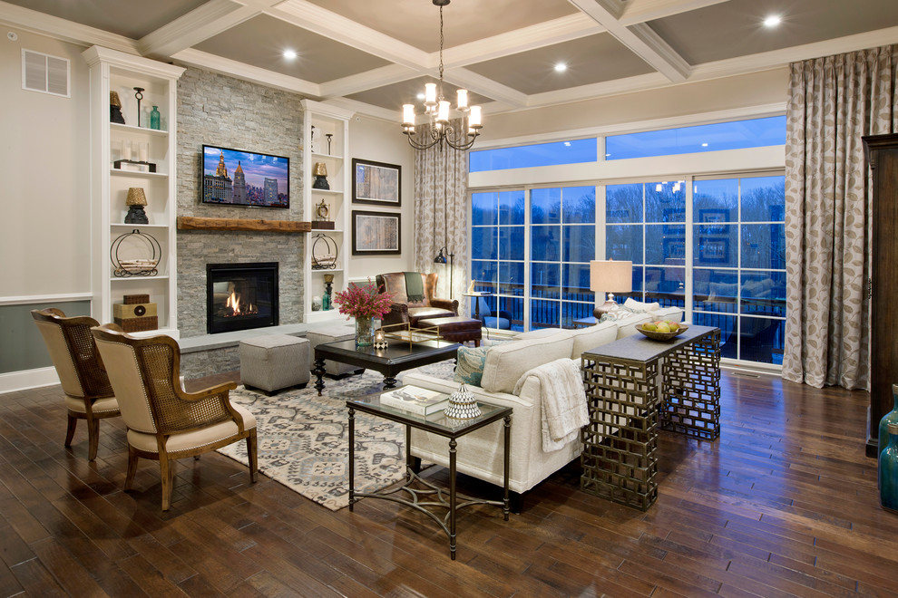Elegant dark wood floor living room photo in Philadelphia with gray walls, a standard fireplace, a stone fireplace and a wall-mounted tv