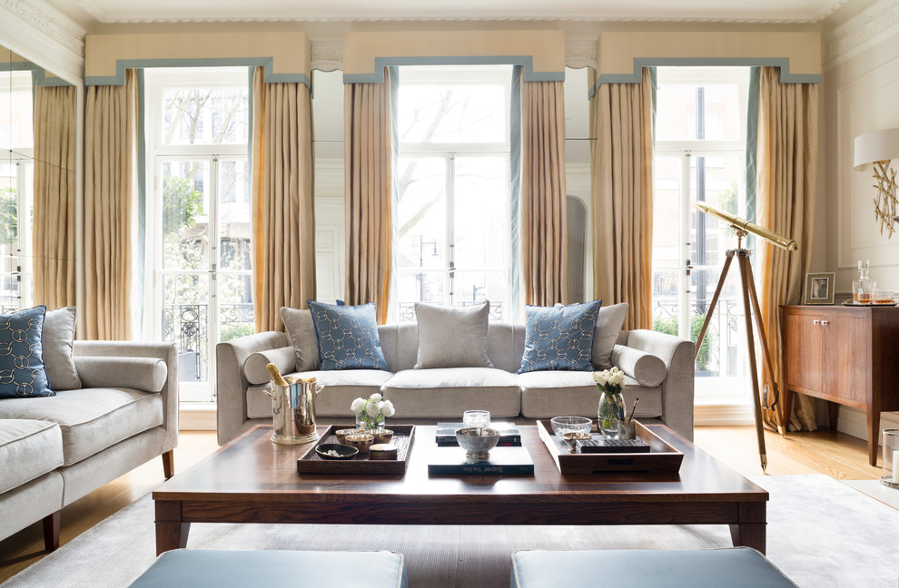 Large classic formal enclosed living room in London with beige walls, medium hardwood flooring and brown floors.