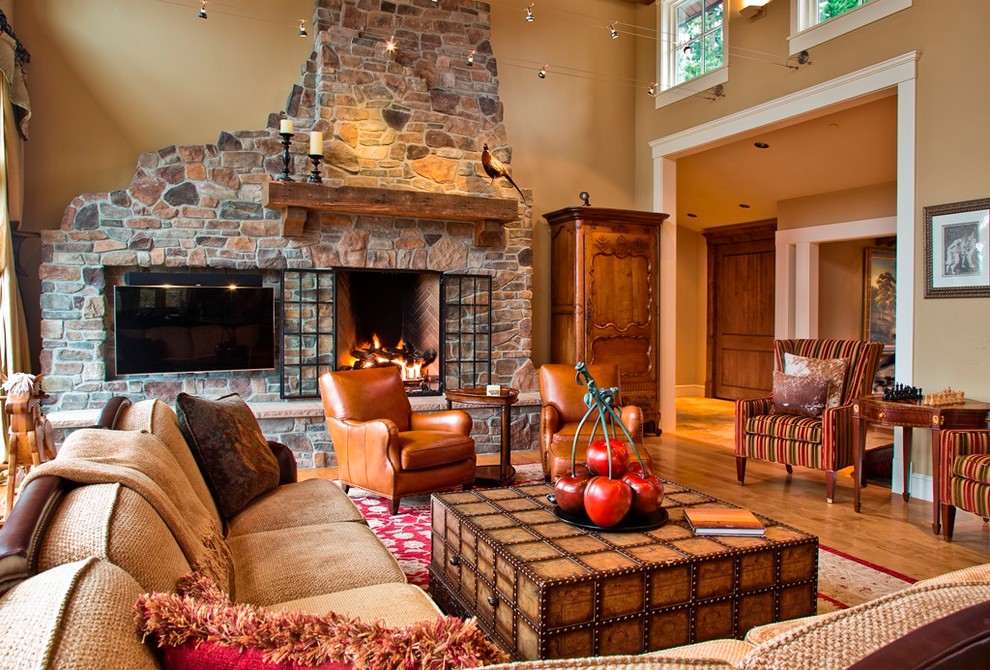 Inspiration for a large rustic enclosed living room in Seattle with medium hardwood flooring, a stone fireplace surround and a built-in media unit.