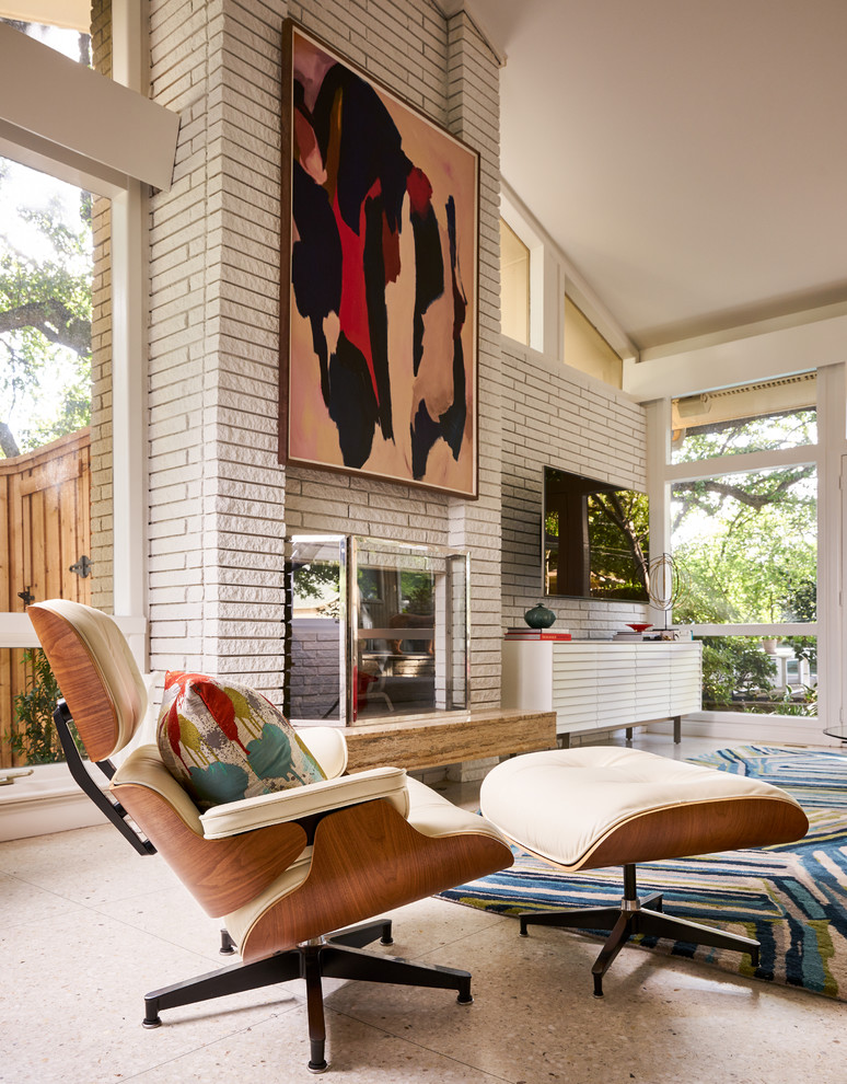 This is an example of a medium sized midcentury open plan living room in Dallas with white walls, medium hardwood flooring, a standard fireplace and a brick fireplace surround.
