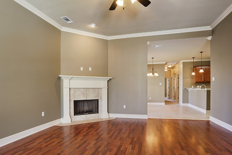 Mid-sized open concept laminate floor living room photo in New Orleans with a corner fireplace and a tile fireplace