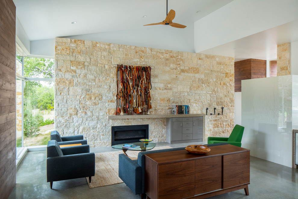 1950s formal concrete floor and gray floor living room photo in Austin with white walls, a ribbon fireplace and a stone fireplace