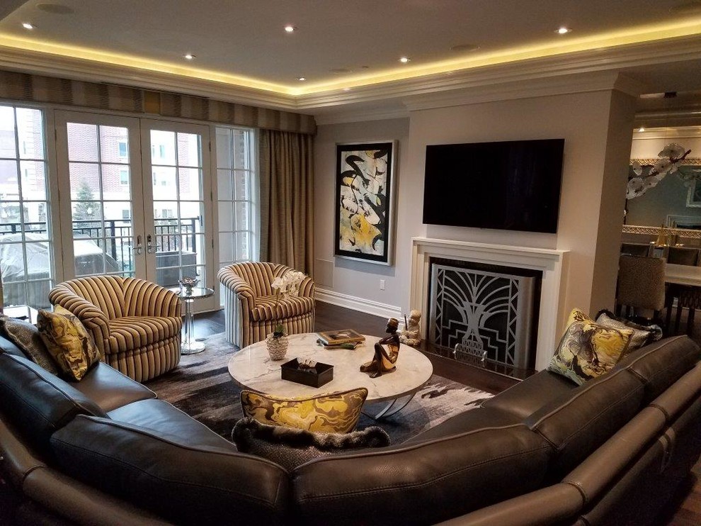 Photo of a medium sized traditional formal open plan living room in New York with grey walls, dark hardwood flooring, a standard fireplace, a wooden fireplace surround, a wall mounted tv and brown floors.