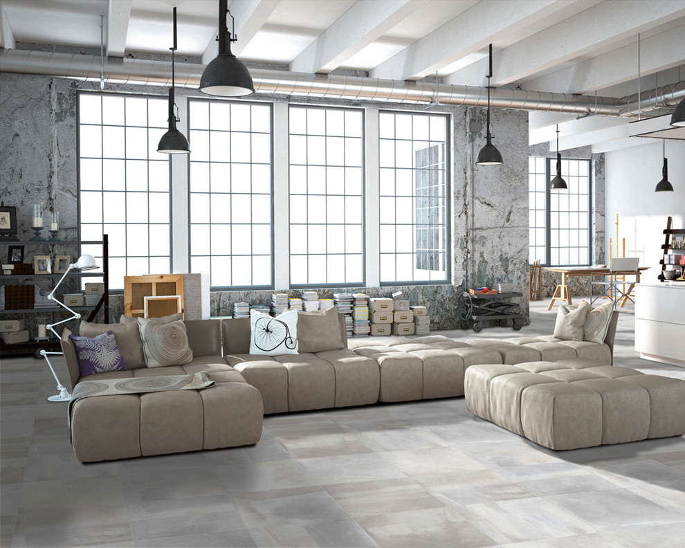 Foto di un grande soggiorno industriale aperto con pareti grigie, pavimento in gres porcellanato, nessun camino e pavimento grigio