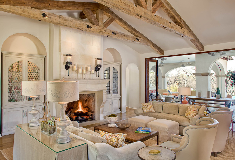 Photo of a large traditional living room in Dallas with beige walls and a standard fireplace.