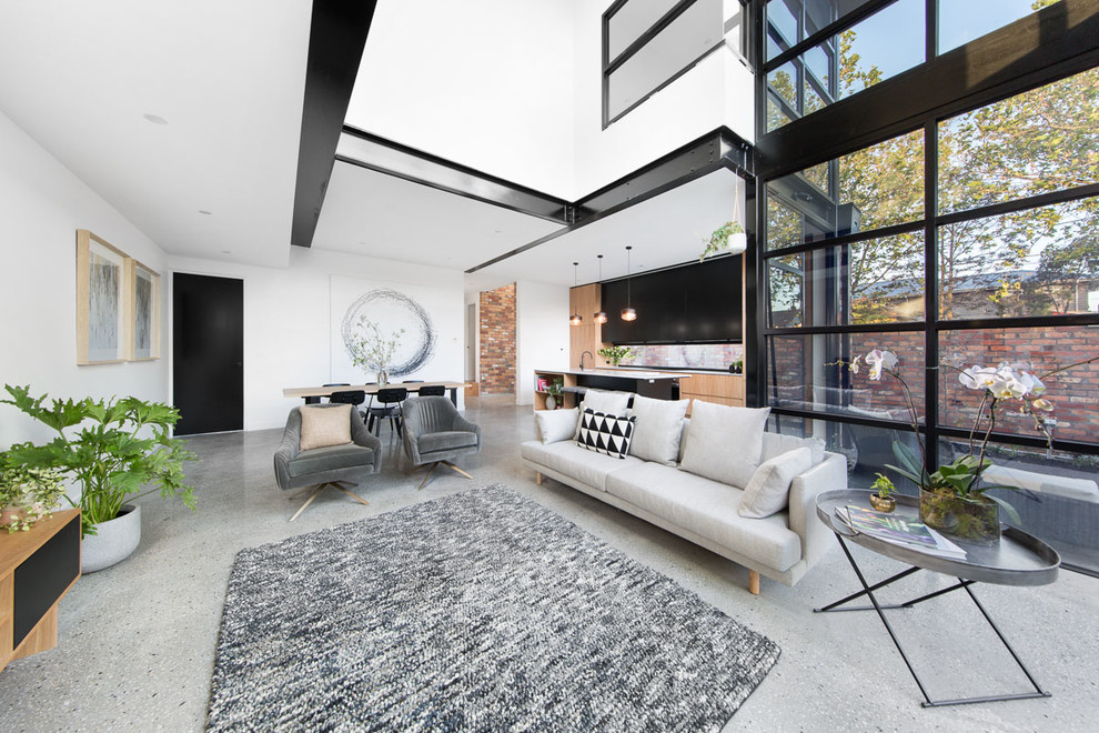 Idee per un soggiorno design di medie dimensioni e stile loft con pareti bianche, pavimento in cemento, camino sospeso e TV autoportante