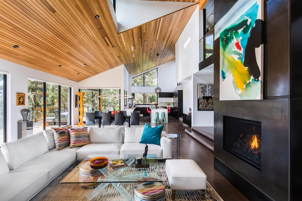 Large contemporary open plan living room in Portland with white walls, medium hardwood flooring, a ribbon fireplace, a metal fireplace surround, a wall mounted tv and brown floors.