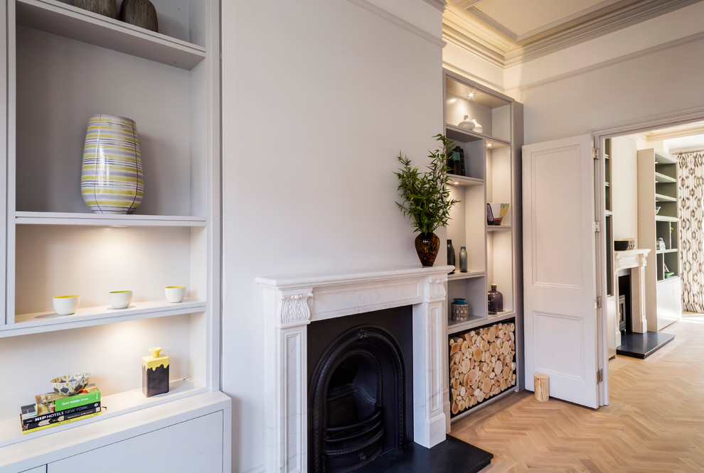 Inspiration for a large victorian open plan living room in London with white walls, light hardwood flooring, a wood burning stove, a stone fireplace surround, a built-in media unit and beige floors.