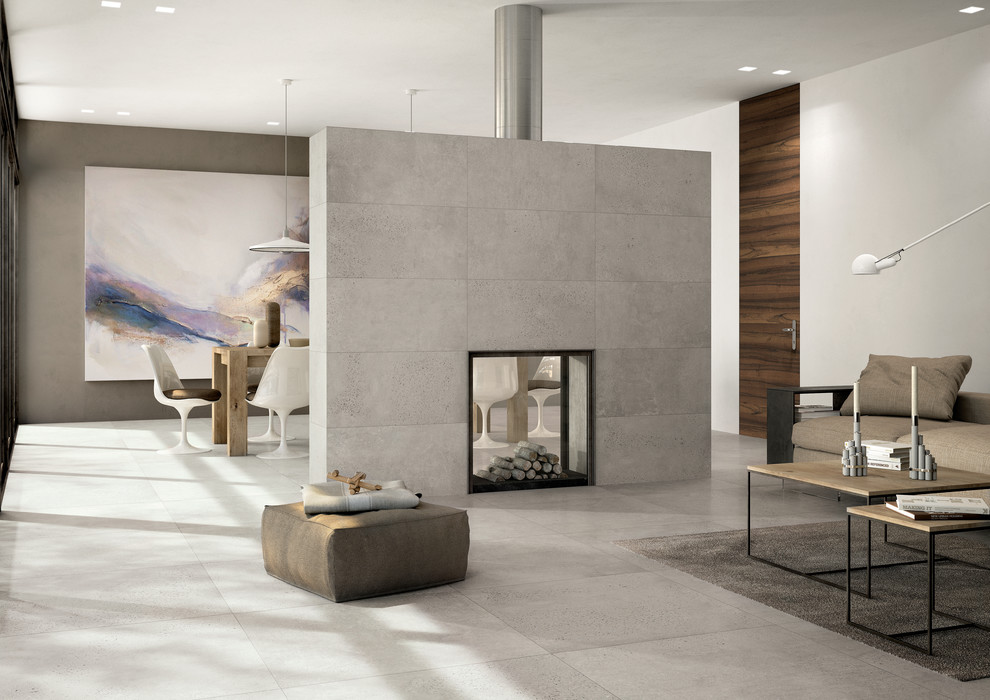 Modelo de salón minimalista con paredes blancas, suelo de baldosas de porcelana, chimenea de doble cara y marco de chimenea de baldosas y/o azulejos