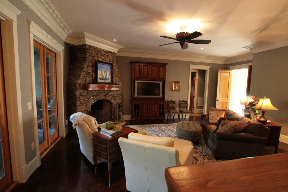 Traditional formal enclosed living room in Other with grey walls, dark hardwood flooring, a corner fireplace, a stone fireplace surround and a built-in media unit.