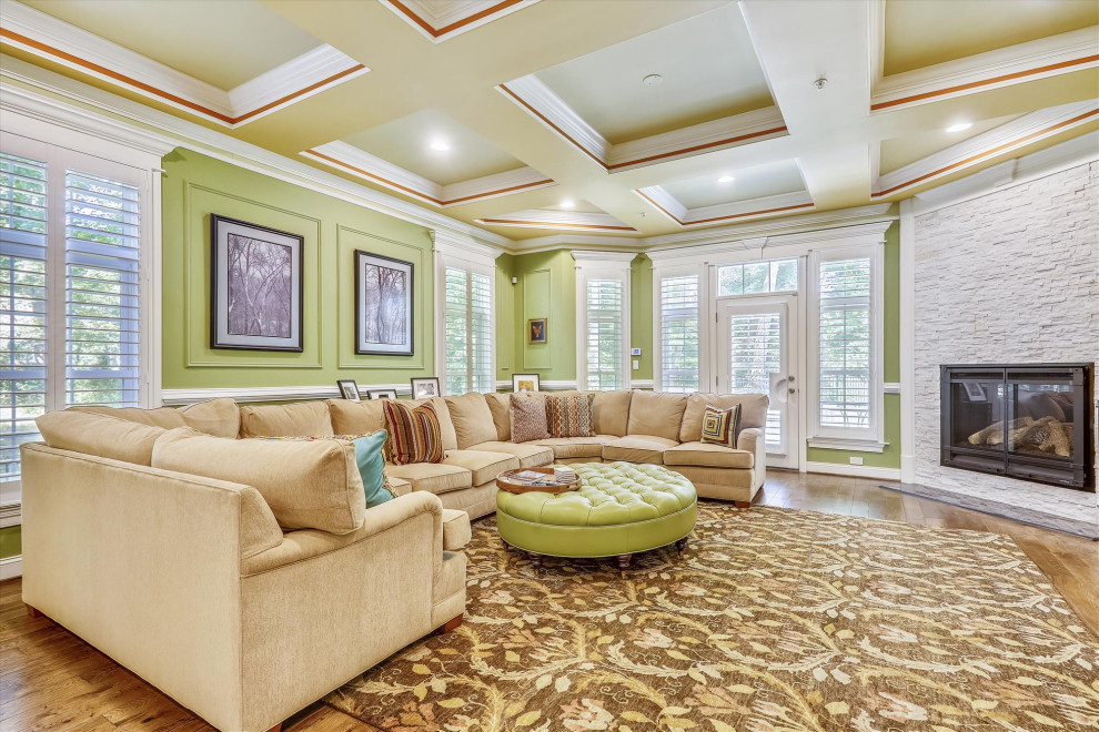 Example of a huge classic formal and enclosed light wood floor and brown floor living room design in DC Metro with brown walls, a corner fireplace, a stone fireplace and no tv