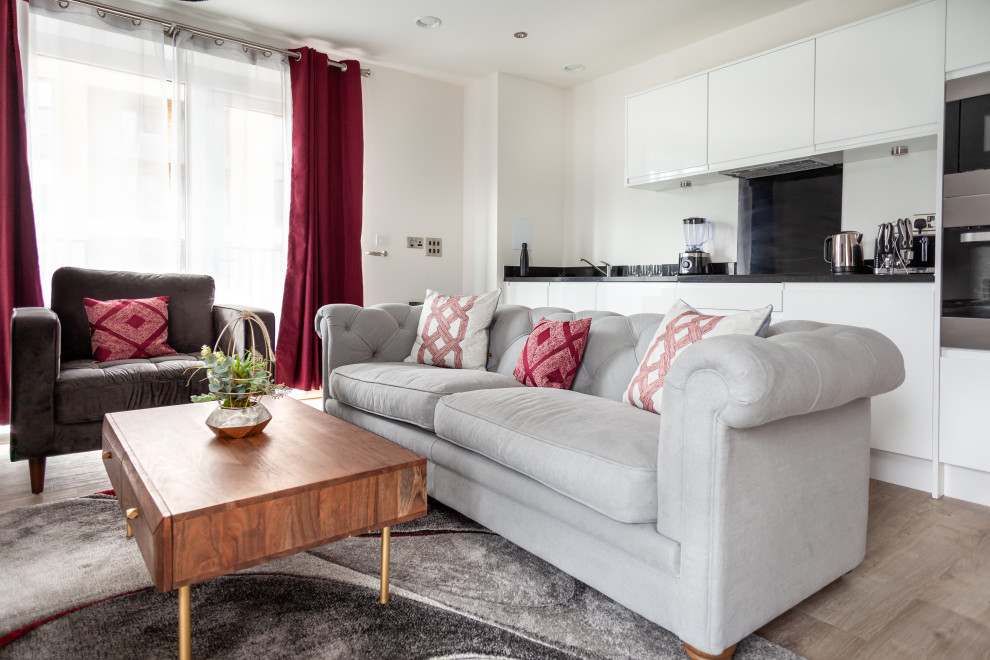 Photo of a medium sized modern formal open plan living room in London with a wall mounted tv, white walls, light hardwood flooring, no fireplace and brown floors.