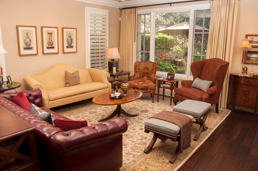 Photo of a medium sized victorian formal open plan living room in San Diego with beige walls, dark hardwood flooring, a standard fireplace, a plastered fireplace surround and no tv.