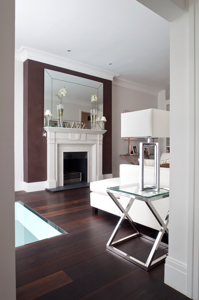 This is an example of a medium sized contemporary formal enclosed living room in London with grey walls, dark hardwood flooring, a standard fireplace and a stone fireplace surround.