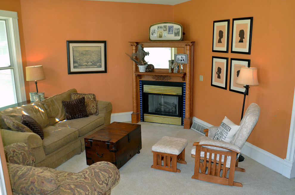 Großes, Repräsentatives, Fernseherloses, Offenes Klassisches Wohnzimmer mit oranger Wandfarbe, Teppichboden und Eckkamin in Sonstige