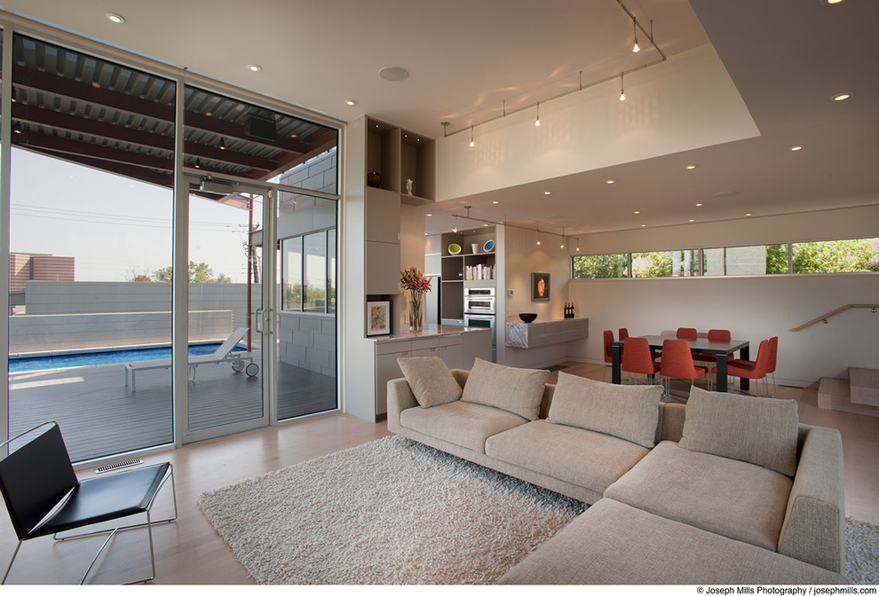 Living room and dining room, with view of patio and pool Modern