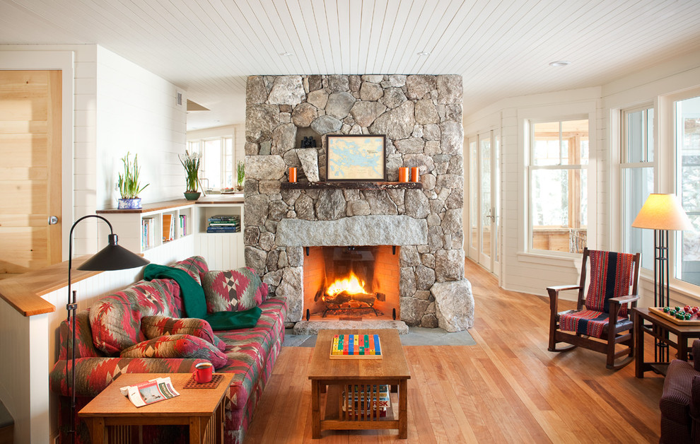 Inspiration for a traditional living room in Boston with a stone fireplace surround.