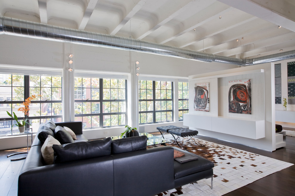 This is an example of an industrial living room in DC Metro with white walls.