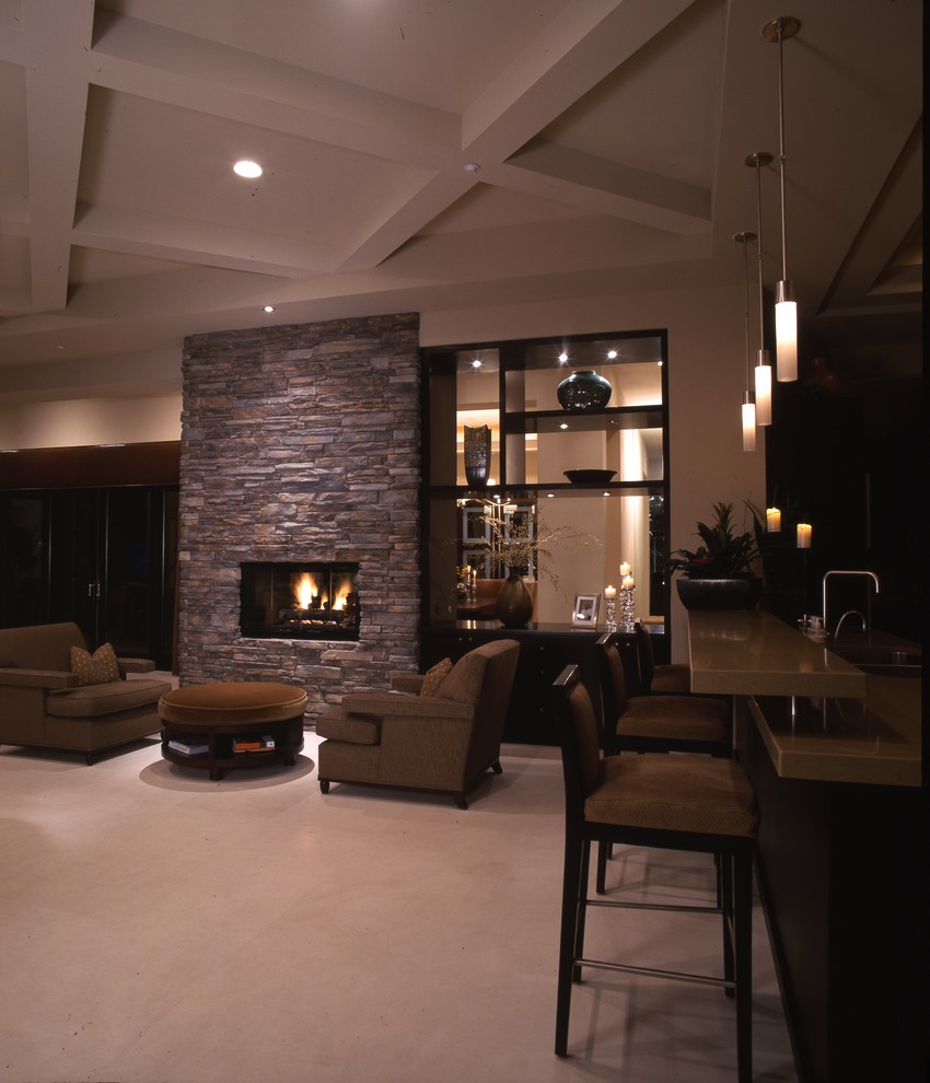 This is an example of an expansive contemporary formal open plan living room in Las Vegas with brown walls, carpet, a corner fireplace, a stone fireplace surround, a wall mounted tv, beige floors, a vaulted ceiling and brick walls.