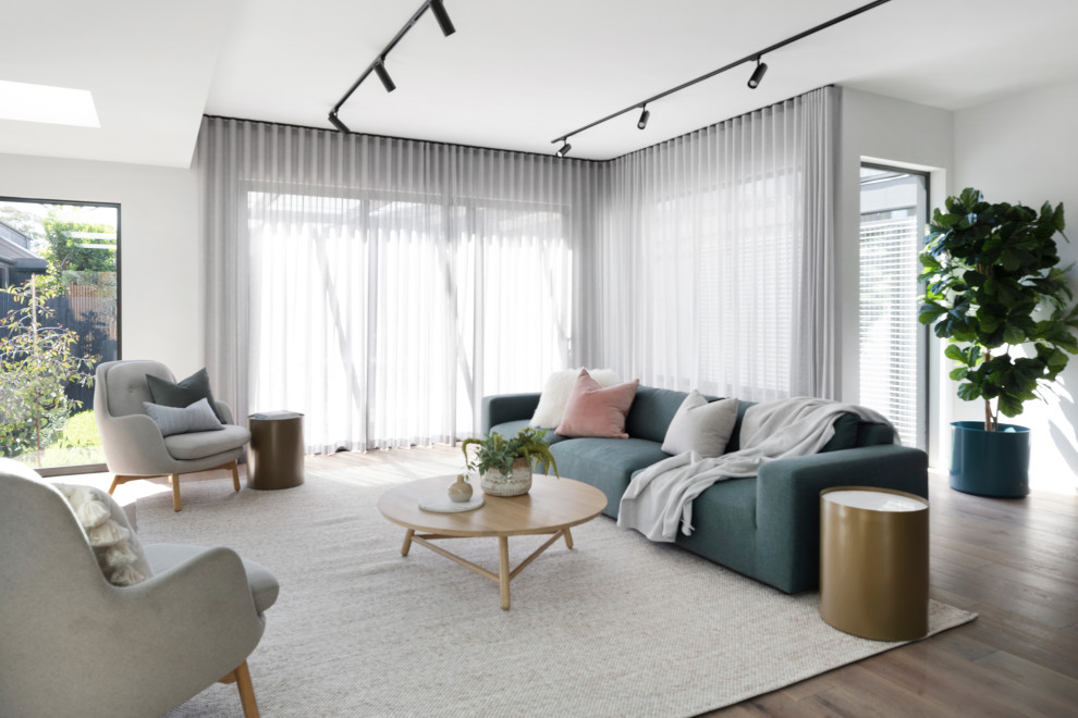 Immagine di un soggiorno contemporaneo aperto e di medie dimensioni con sala formale, pareti bianche, nessuna TV, pavimento marrone e pavimento in legno massello medio