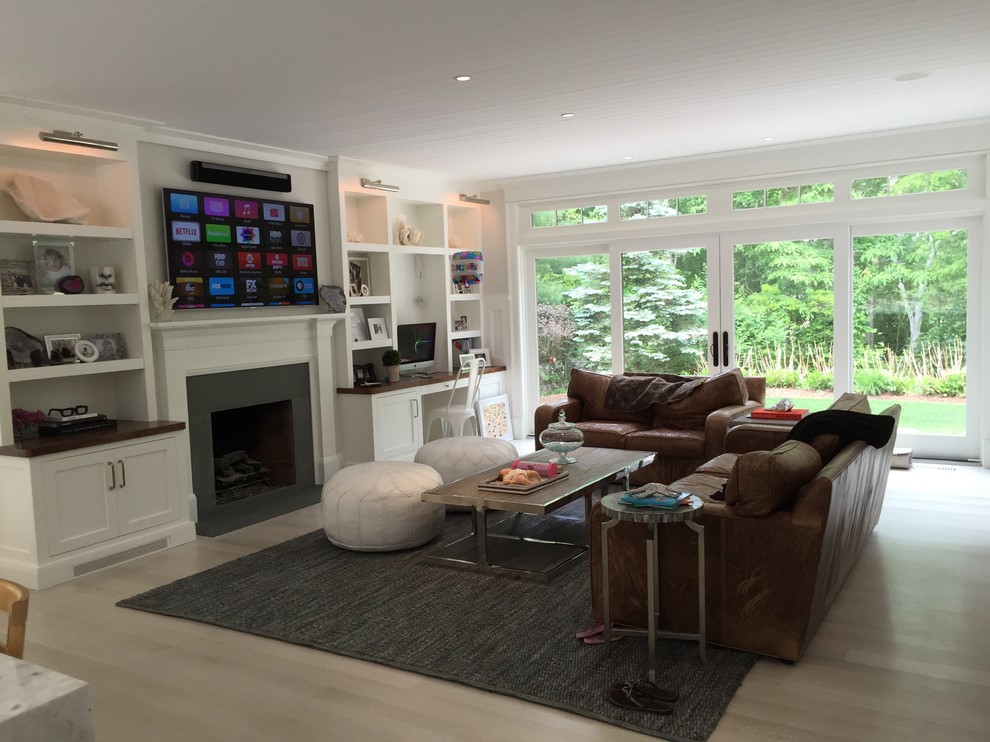 Photo of a large traditional open plan living room in Other with white walls, bamboo flooring, a standard fireplace, a plastered fireplace surround and a wall mounted tv.