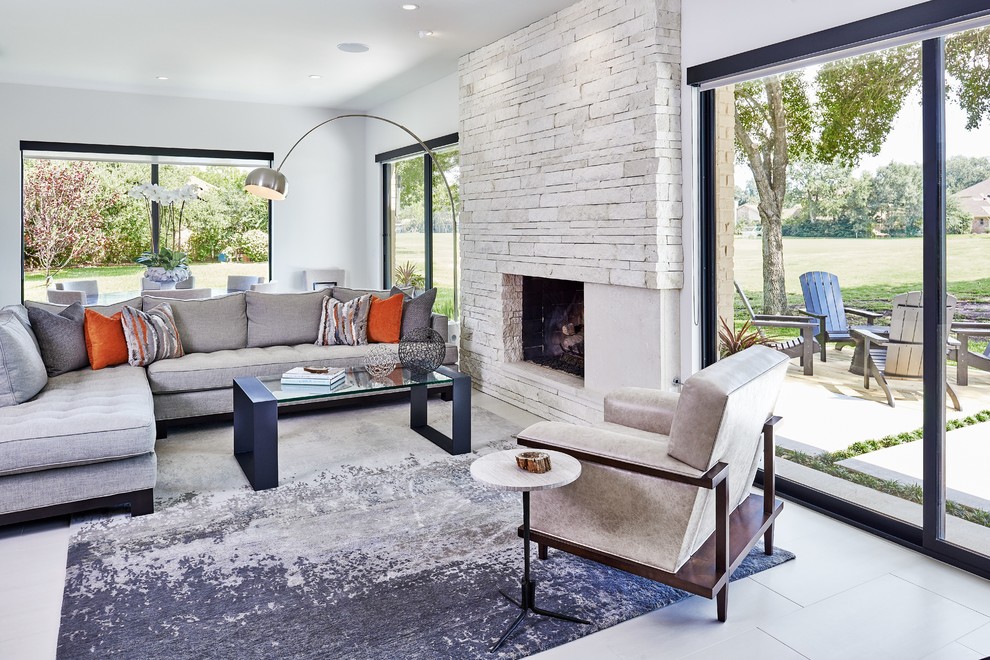 This is an example of a medium sized contemporary formal enclosed living room in Houston with porcelain flooring, a standard fireplace, a stone fireplace surround, white walls and no tv.