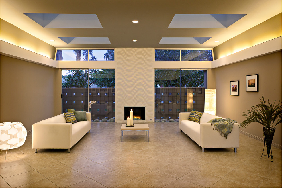Aménagement d'un grand salon rétro ouvert avec un mur beige, un sol en carrelage de porcelaine, une cheminée standard et un manteau de cheminée en carrelage.