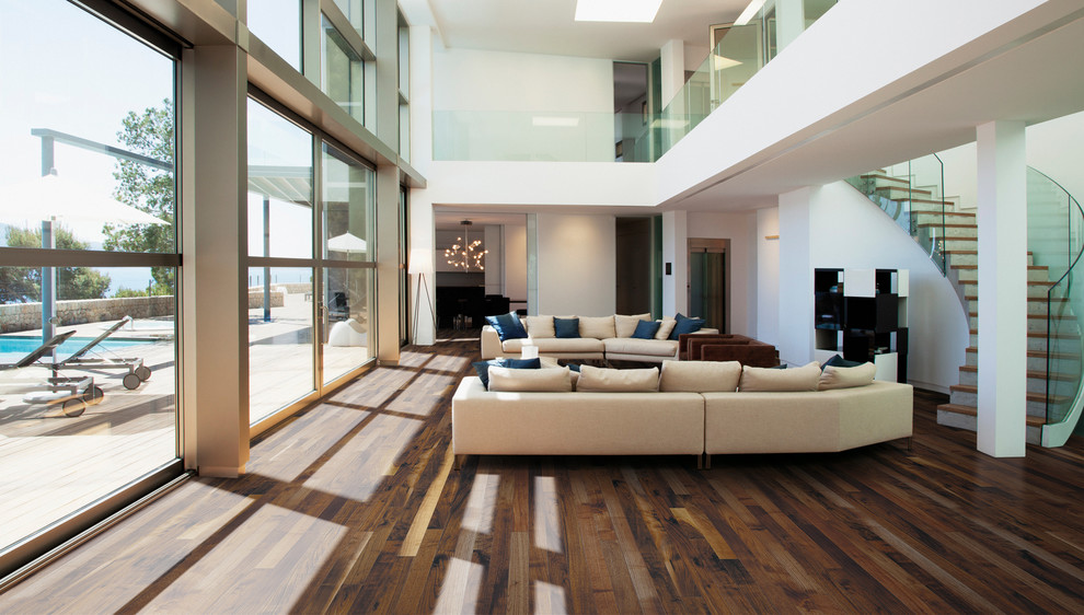 Photo of a large contemporary formal open plan living room in Montreal with white walls, dark hardwood flooring, no fireplace, no tv and brown floors.