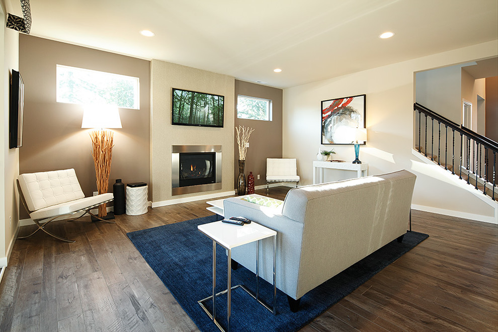 Photo of a large contemporary formal open plan living room in Seattle with beige walls, dark hardwood flooring, a metal fireplace surround, a wall mounted tv and a standard fireplace.