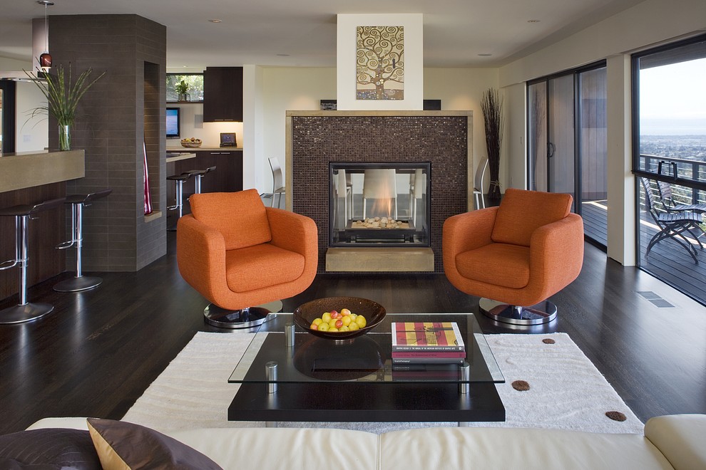 Example of a trendy brown floor living room design in San Francisco with a tile fireplace