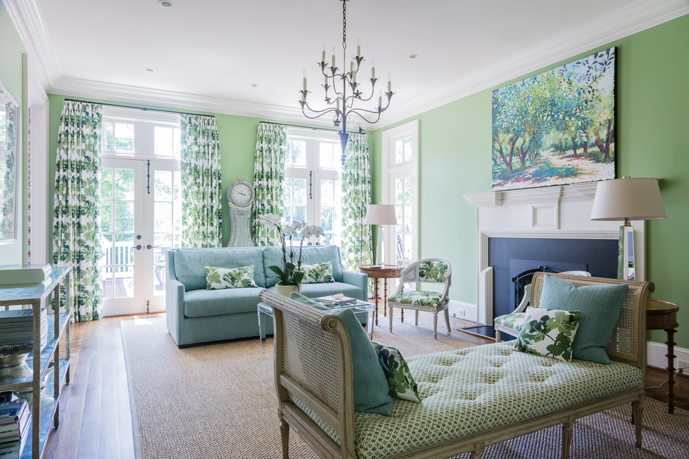 На фото: изолированная гостиная комната среднего размера в классическом стиле с зелеными стенами, паркетным полом среднего тона, стандартным камином и синим диваном без телевизора