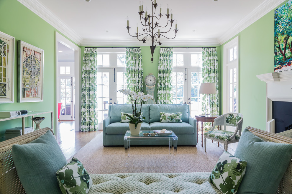 Inspiration for a medium sized classic enclosed living room in Raleigh with green walls, medium hardwood flooring, a standard fireplace and no tv.