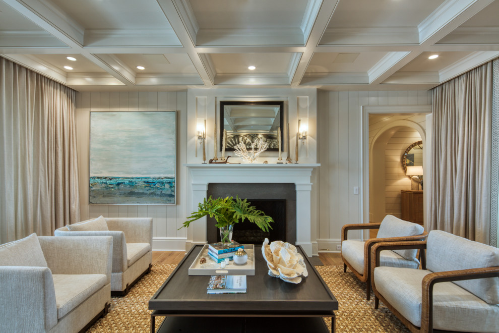 Inspiration for a nautical living room in Jacksonville with a standard fireplace, brown floors, a coffered ceiling, white walls, a stone fireplace surround, wood walls and light hardwood flooring.