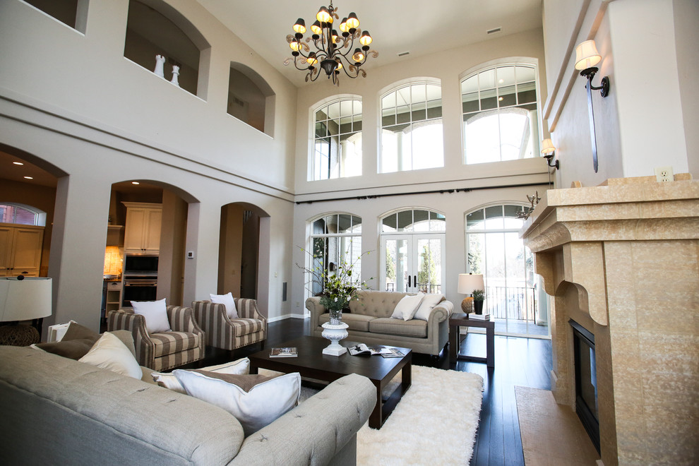 Inspiration for a huge transitional formal and enclosed dark wood floor and black floor living room remodel in Minneapolis with gray walls, a standard fireplace, a stone fireplace and a concealed tv