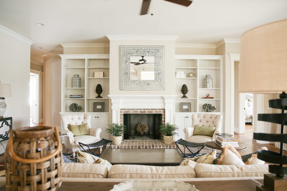 Living room - large coastal enclosed medium tone wood floor living room idea in Atlanta with a standard fireplace, a brick fireplace and no tv