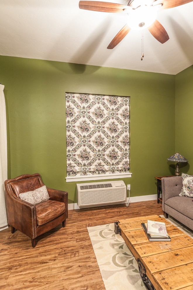 Small traditional formal enclosed living room in Denver with green walls, medium hardwood flooring, no fireplace, no tv and brown floors.