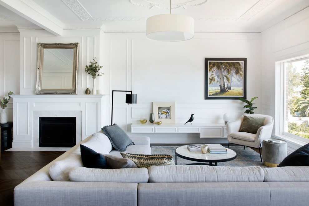 Esempio di un soggiorno chic con pareti bianche, parquet scuro, camino classico e pavimento marrone