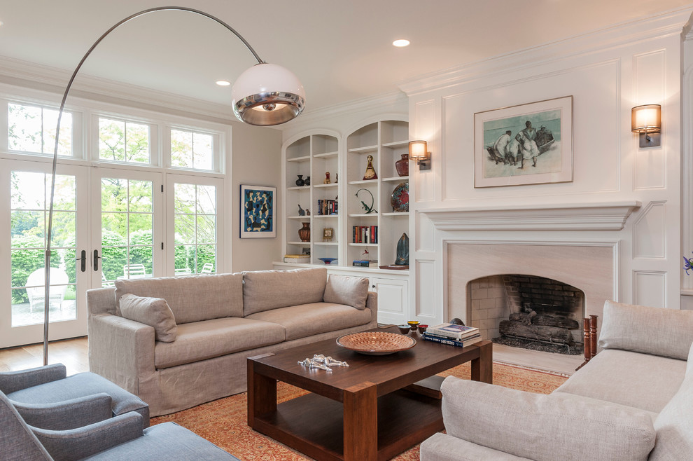 Medium sized classic enclosed living room in Indianapolis with white walls, medium hardwood flooring, a standard fireplace, a stone fireplace surround and brown floors.
