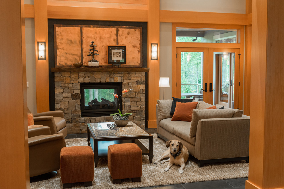 Photo of a classic open plan living room in Seattle with a two-sided fireplace and a stone fireplace surround.