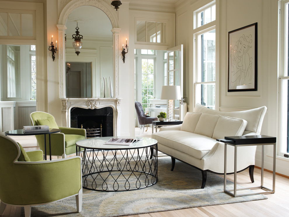 Photo of a large victorian formal enclosed living room in Other with white walls, light hardwood flooring, a standard fireplace, a stone fireplace surround, no tv and feature lighting.