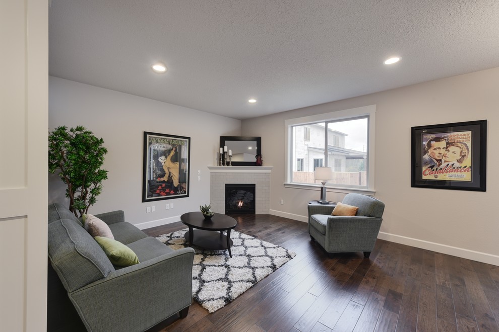 Offenes Klassisches Wohnzimmer mit weißer Wandfarbe, dunklem Holzboden, Eckkamin und gefliester Kaminumrandung in Portland