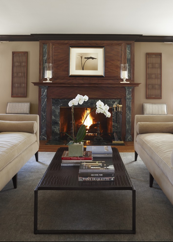 Photo of a traditional living room in Detroit with beige walls, a standard fireplace and a stone fireplace surround.