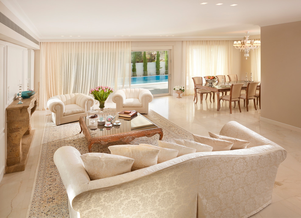 Example of a classic open concept marble floor living room design in Other with beige walls and no tv