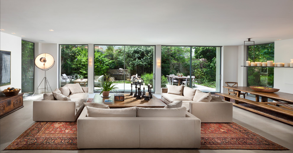 Photo of an expansive contemporary living room in Other with white walls.