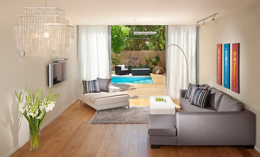 Living room - mid-sized contemporary living room idea in Other with a wall-mounted tv
